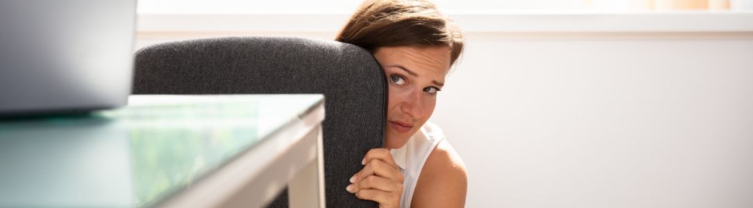 Panic Button Woman Hiding Behind Desk